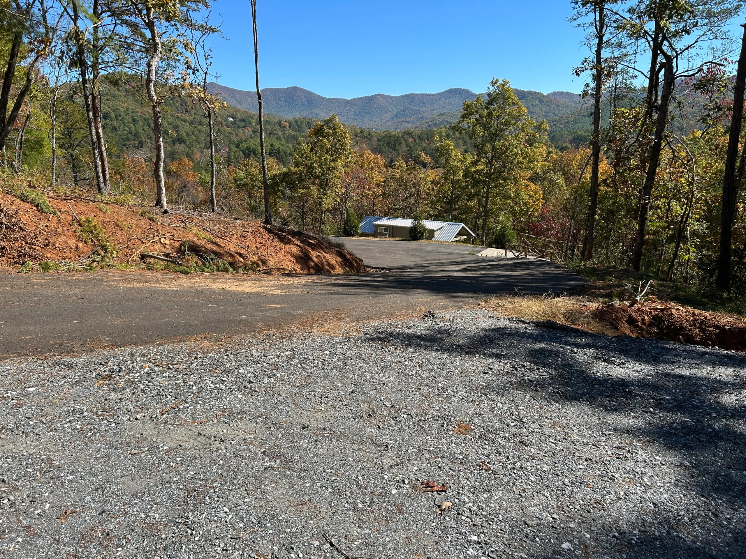 Newly cleared gravel area leading to a paved road